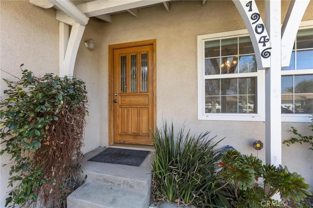 property entrance with stucco siding