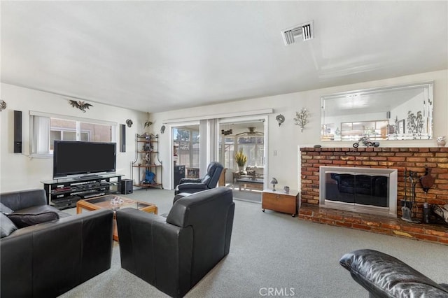 carpeted living area with a brick fireplace and visible vents