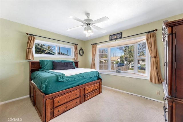 bedroom featuring baseboards and light colored carpet