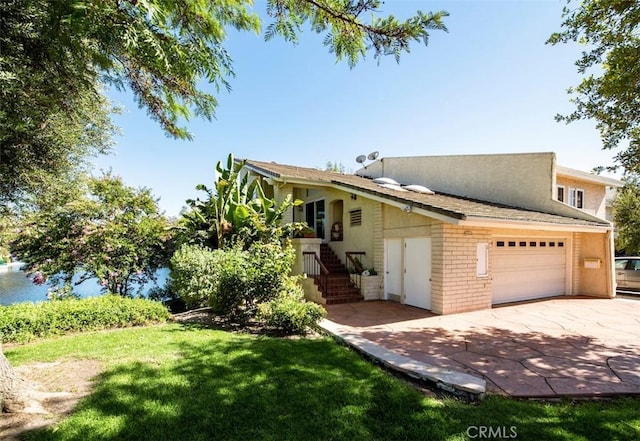 view of front of house featuring an attached garage, a front lawn, and concrete driveway