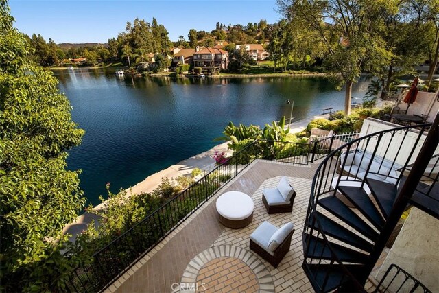 balcony with a patio area and a water view