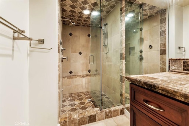 full bathroom with a shower stall and vanity