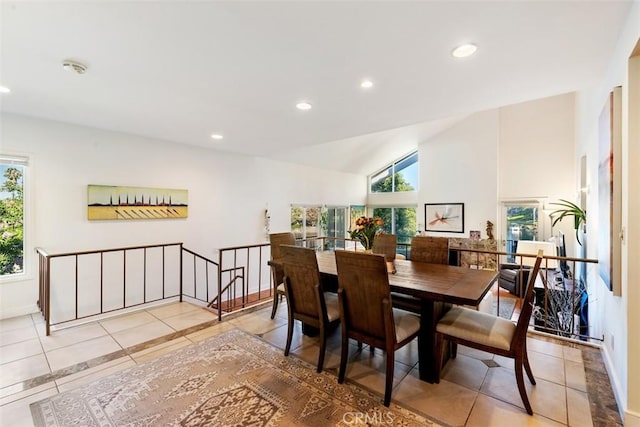 dining room featuring vaulted ceiling, light tile patterned flooring, a wealth of natural light, and recessed lighting