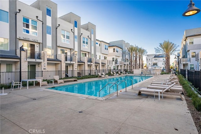 pool featuring a residential view, fence, and a patio