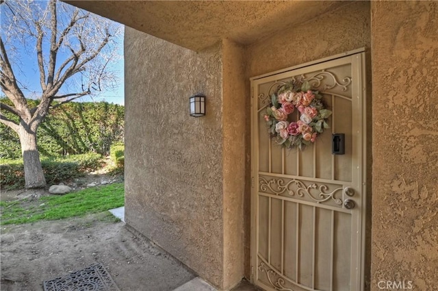 doorway to property with stucco siding