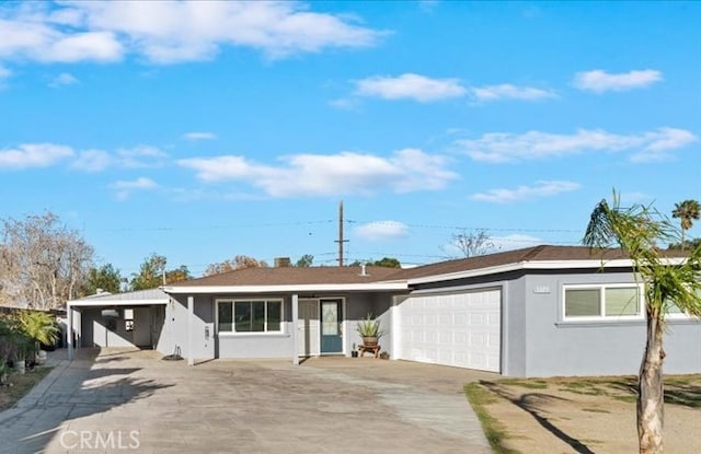 single story home with a garage, driveway, and stucco siding