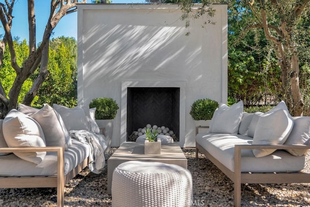 view of outbuilding with an outdoor living space with a fireplace