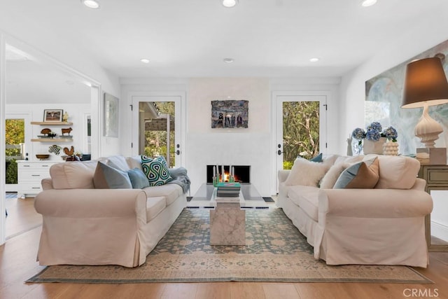 living area with wood finished floors and recessed lighting