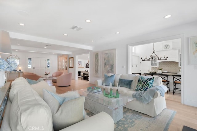 living room featuring a notable chandelier, recessed lighting, visible vents, and light wood-style floors