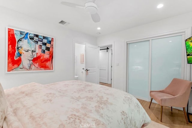 bedroom featuring recessed lighting, a closet, visible vents, and wood finished floors