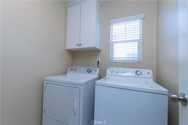 laundry room featuring cabinet space and washing machine and clothes dryer