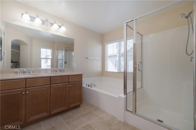 full bath featuring double vanity, a stall shower, a sink, and a bath