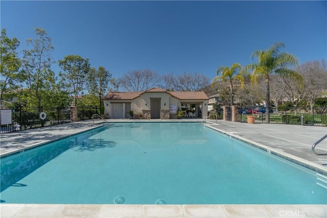 community pool featuring a patio area and fence