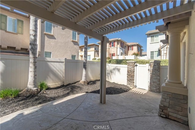 view of patio featuring a fenced backyard, a residential view, and a pergola