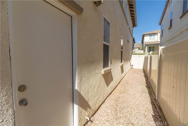 view of property exterior with a fenced backyard and stucco siding