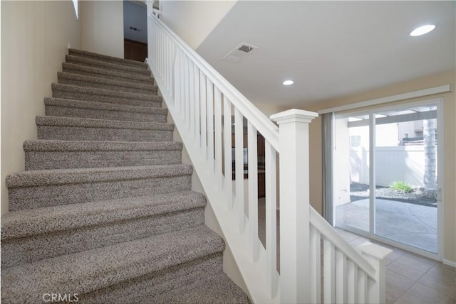 stairs with tile patterned floors, visible vents, and recessed lighting