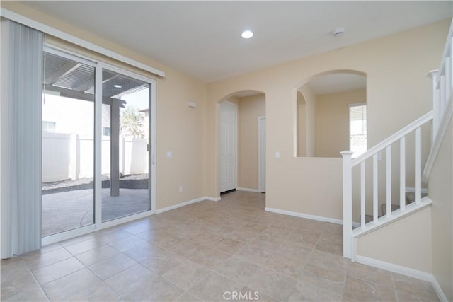 unfurnished room with light tile patterned floors, stairs, baseboards, and recessed lighting