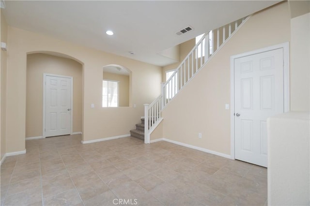 unfurnished room featuring baseboards, stairs, visible vents, and recessed lighting