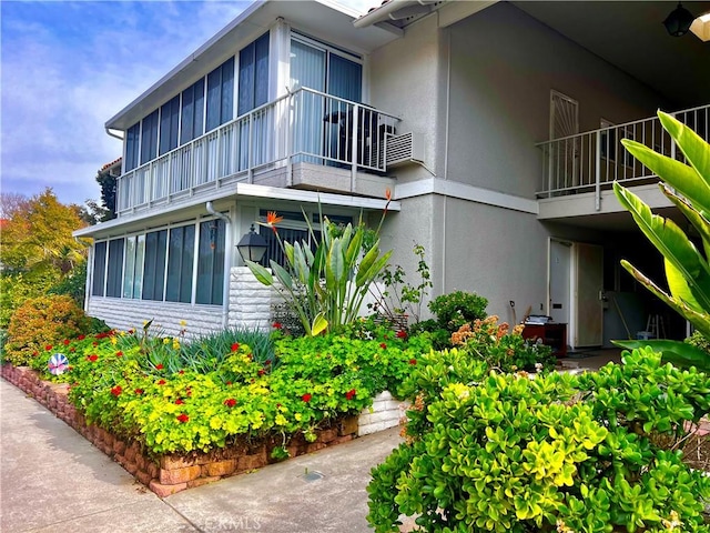 view of property exterior with a balcony and stucco siding