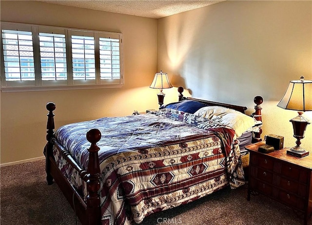 carpeted bedroom featuring baseboards and a textured ceiling