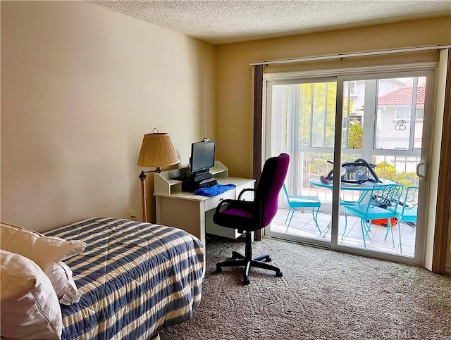 bedroom with access to exterior, carpet, and a textured ceiling