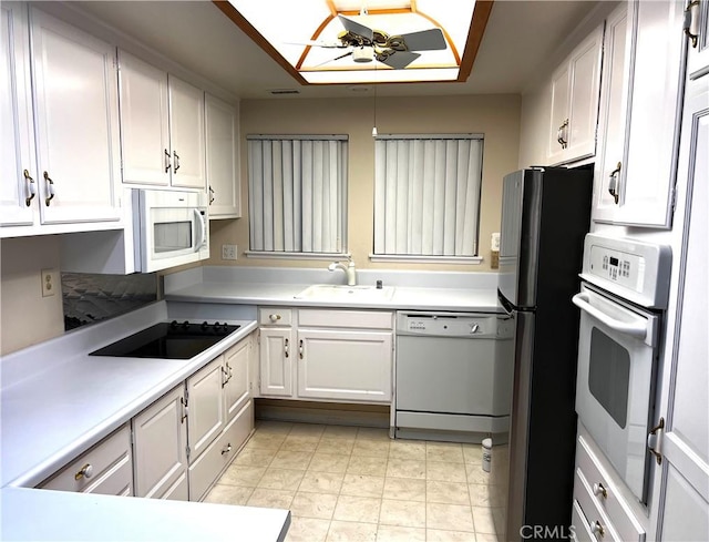 kitchen with light countertops, a ceiling fan, white cabinetry, a sink, and white appliances