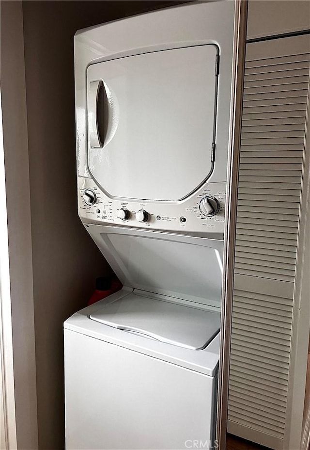 laundry room featuring stacked washer and clothes dryer and laundry area