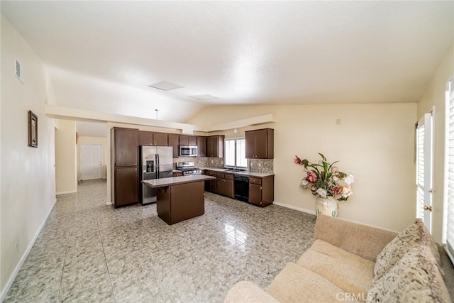 kitchen with dark brown cabinetry, baseboards, decorative backsplash, a center island, and stainless steel appliances