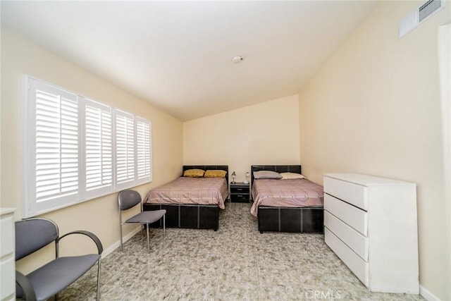 carpeted bedroom with lofted ceiling, baseboards, and visible vents