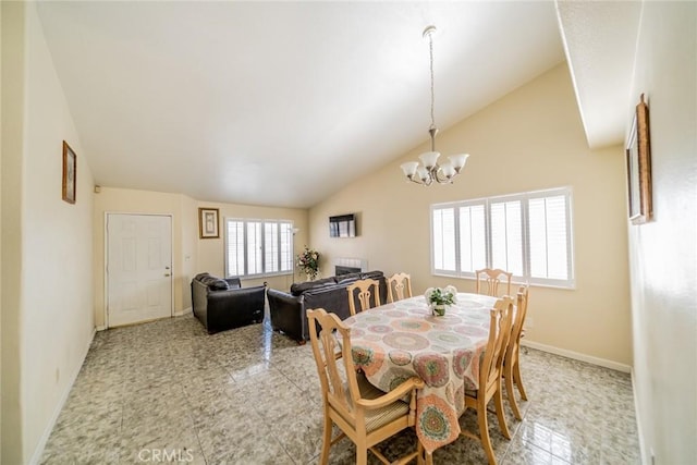 dining room with baseboards, vaulted ceiling, and a notable chandelier