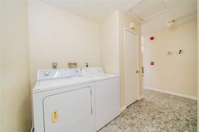 laundry room featuring laundry area, attic access, baseboards, and separate washer and dryer