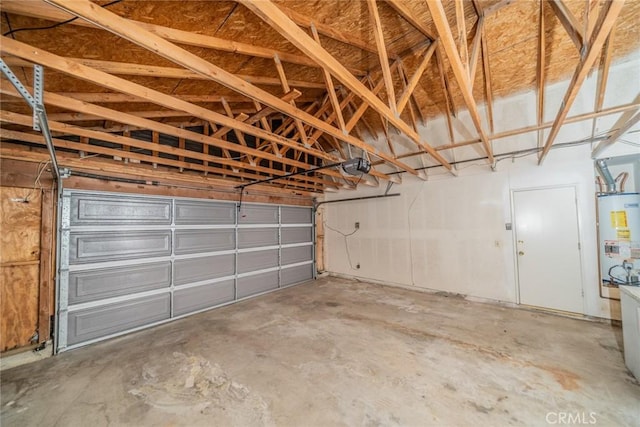 garage with gas water heater and a garage door opener