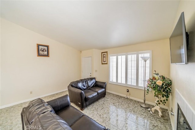 living area featuring baseboards