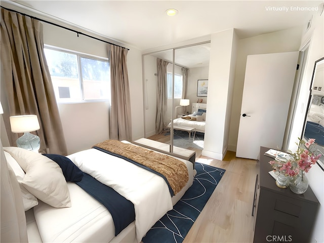 bedroom with light wood-style floors and a closet