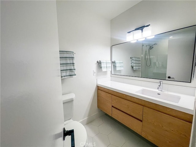 full bath featuring a shower, vanity, toilet, and tile patterned floors