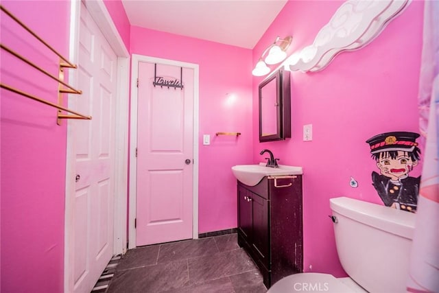 bathroom with toilet and vanity