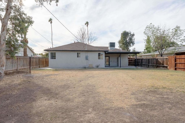 rear view of property featuring a patio and a fenced backyard