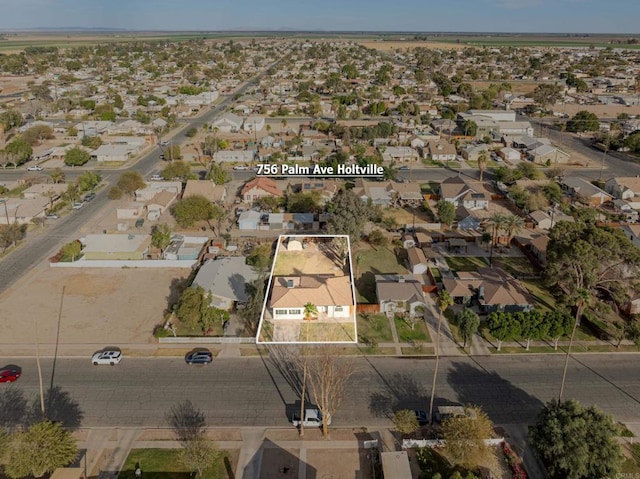 birds eye view of property with a residential view