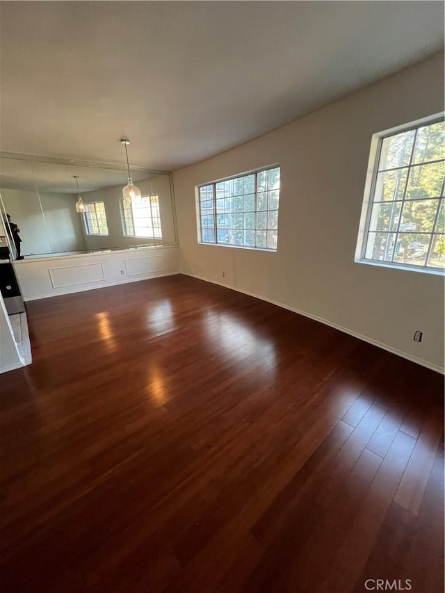 unfurnished living room featuring dark wood finished floors