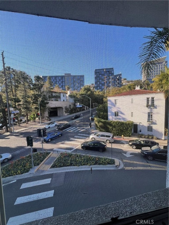 view of road featuring a city view and curbs