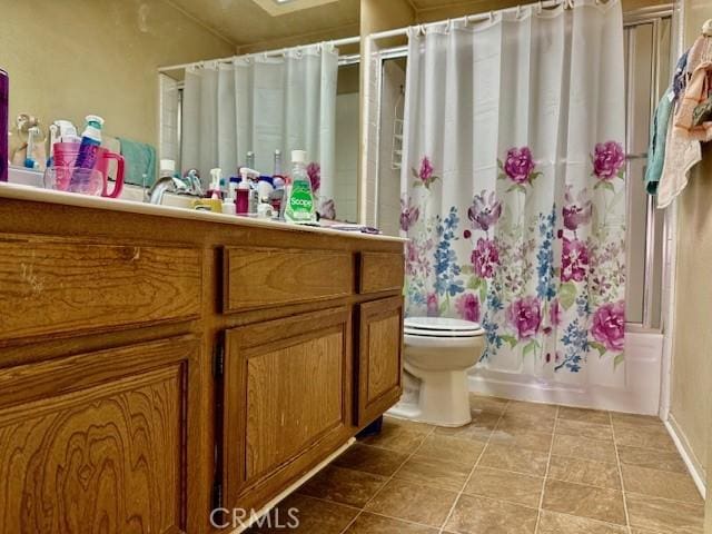 full bath with toilet, tile patterned flooring, shower / bath combination with curtain, and vanity