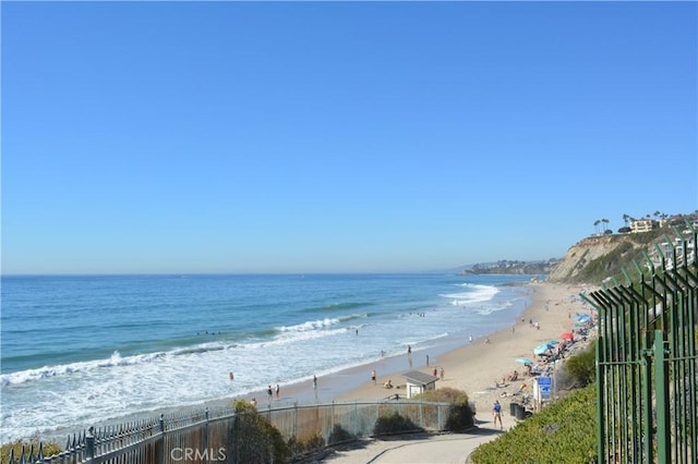 water view with a view of the beach and fence