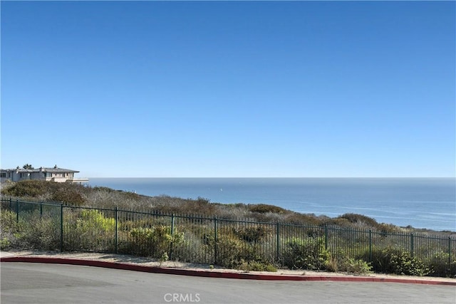 property view of water featuring fence