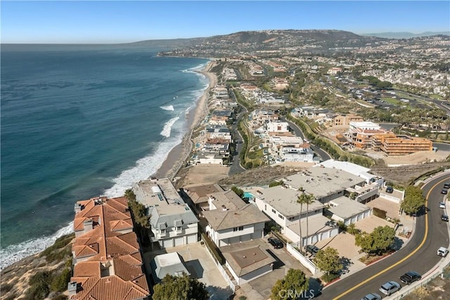 bird's eye view featuring a beach view, a water view, and a residential view