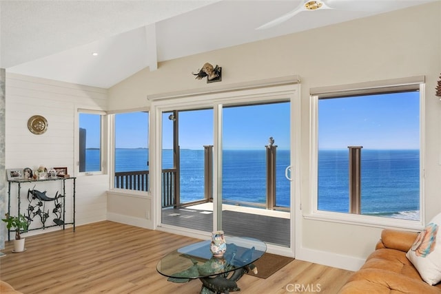 sunroom / solarium featuring a water view and a wealth of natural light