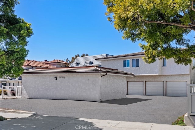 exterior space with stucco siding and fence