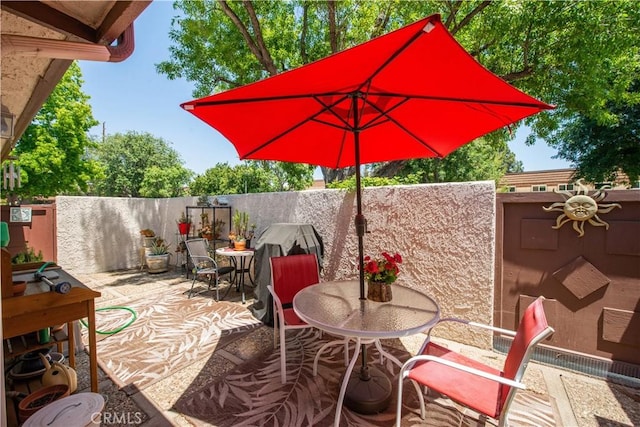 view of patio / terrace with outdoor dining space and fence