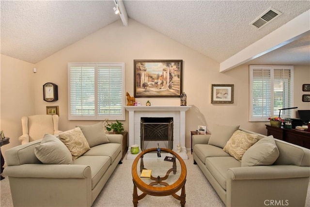 living area with a brick fireplace, visible vents, plenty of natural light, and carpet flooring