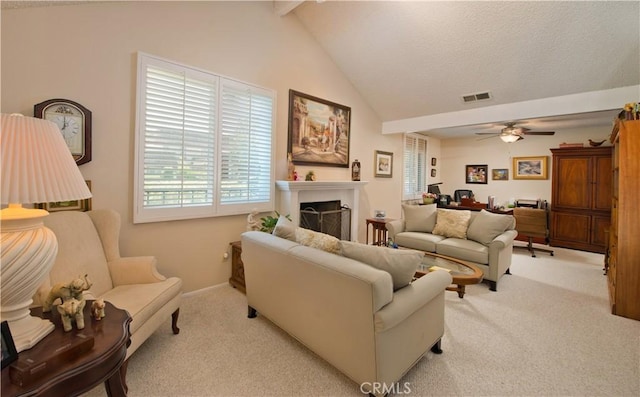 living area featuring visible vents, a ceiling fan, light colored carpet, beamed ceiling, and a fireplace