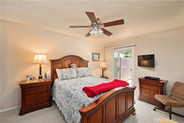 bedroom featuring access to outside, light carpet, ceiling fan, and a textured ceiling